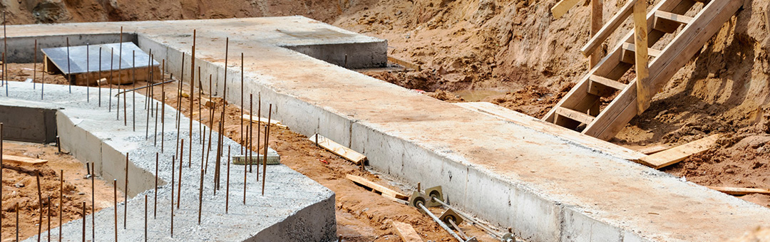 Site of cement and rebar forming the foundation of a building at a construction site